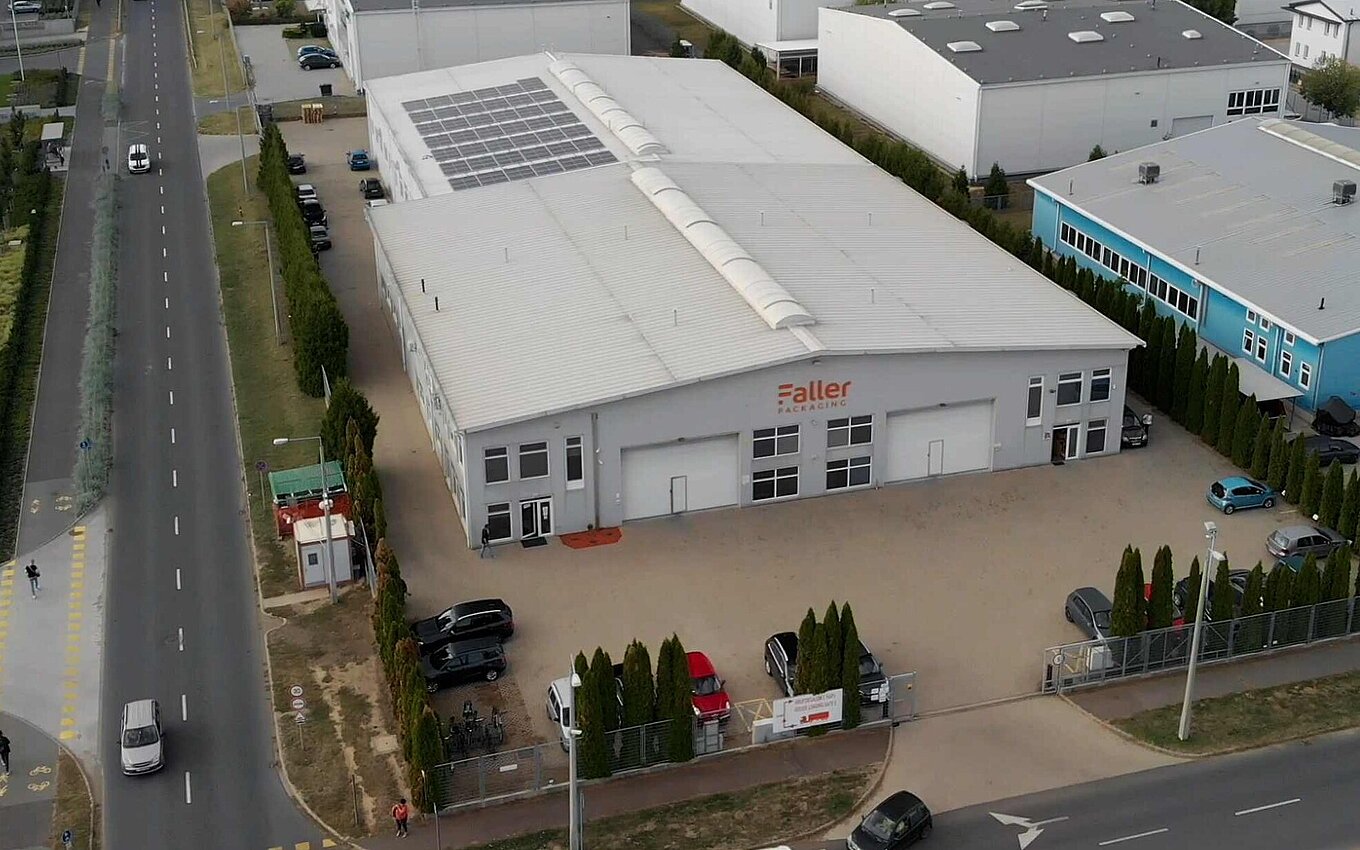 Aerial view of the Faller Packaging plant in Debrecen with solar panels and company logo on the facade
